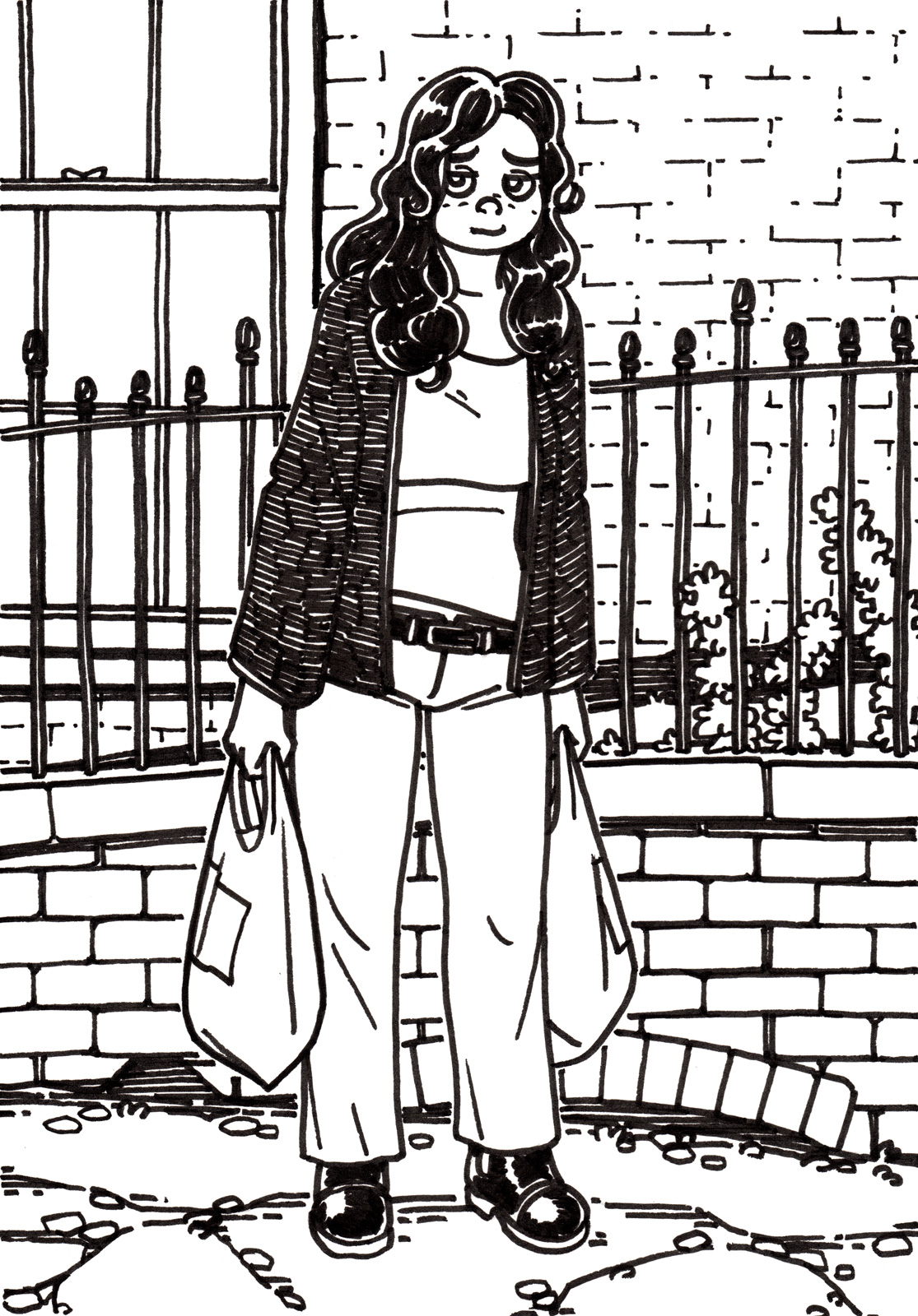 A tired girl slouching with a shopping bag in each hand, standing on a path in front of an old fence and rough brick wall.